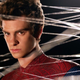 Peter Parker, wearing his Spider-Man suit but maskless, stands amid spider webs.